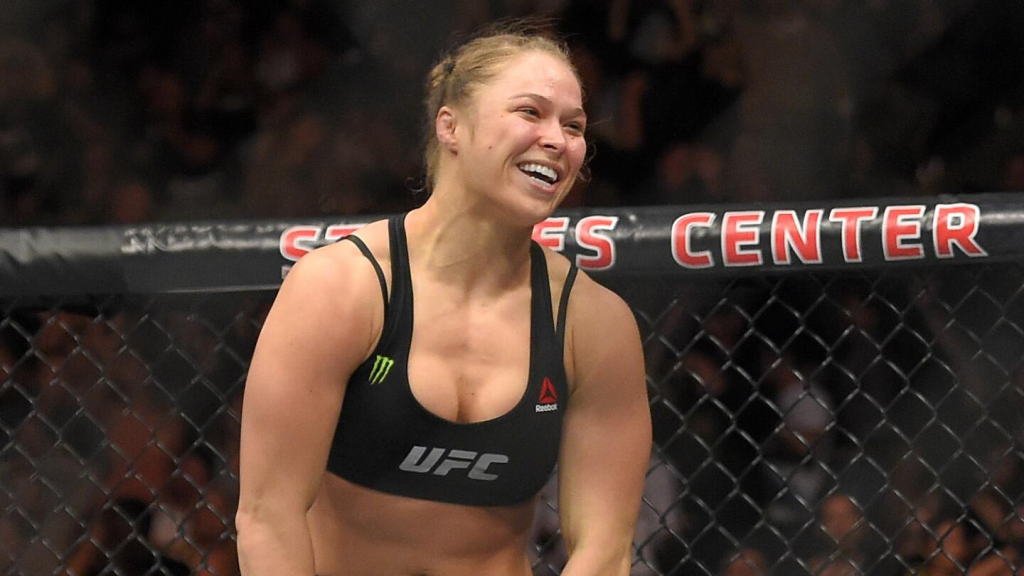 Ronda Rousey returns to MMA against Gina Carano on May 16 at Intuit Dome. Historic matchup streamed live on Netflix, marking a decade since Rousey’s last fight.