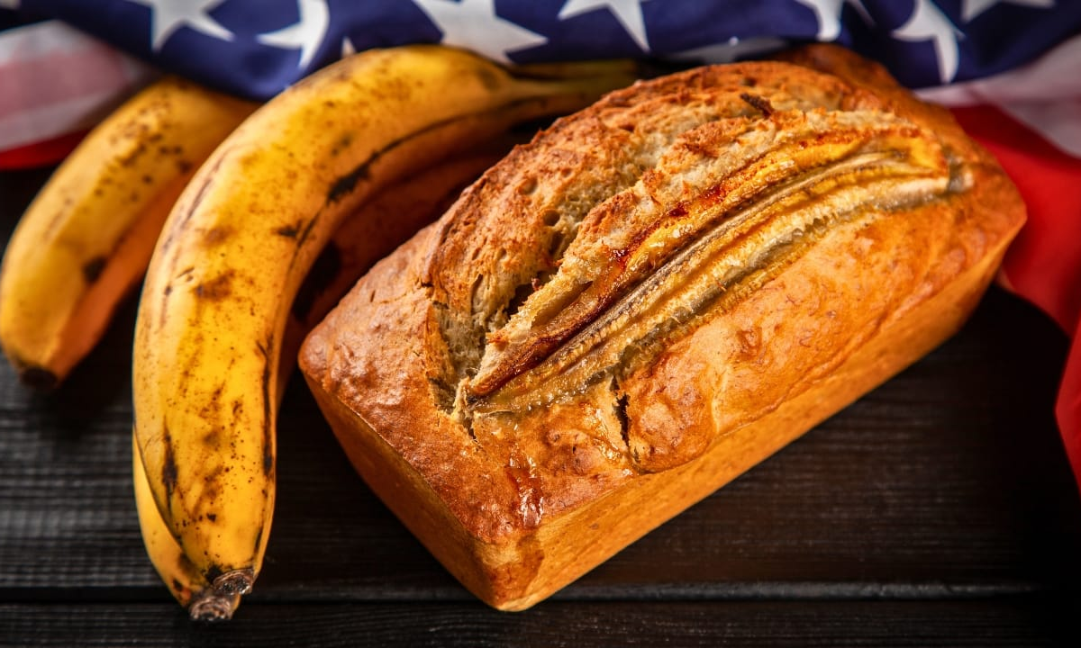 Banana bread recipe and history. Discover how to use simple pantry staples to create a delicious and moist American quick bread that everyone will love.
