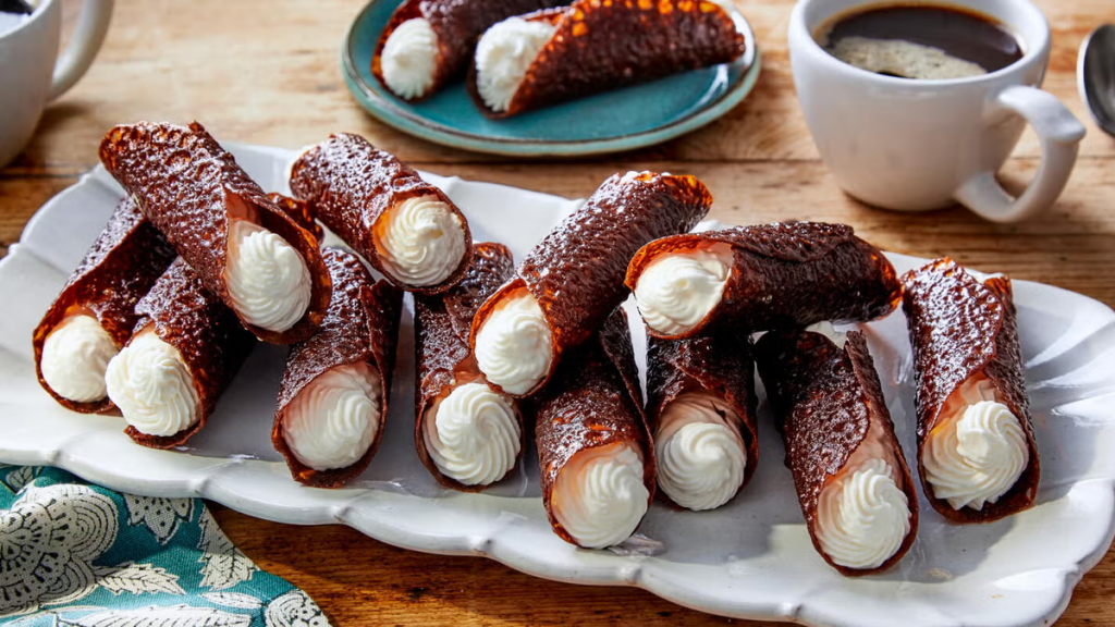 Brandy snaps recipe from the royal chef of Queen Elizabeth II. Learn how to bake crispy ginger lace rolls filled with sweet brandy whipped cream at home easily.