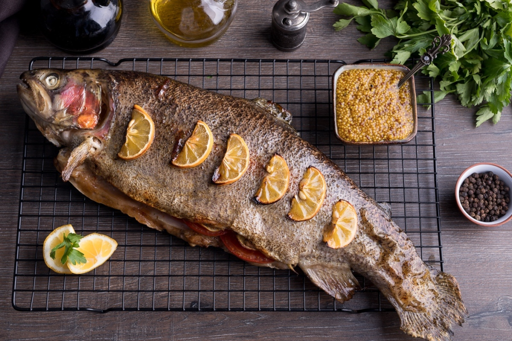 Dominique Crenn baked trout recipe provides a professional guide to making Michelin star seafood at home with a classic French Bearnaise sauce and parchment technique.