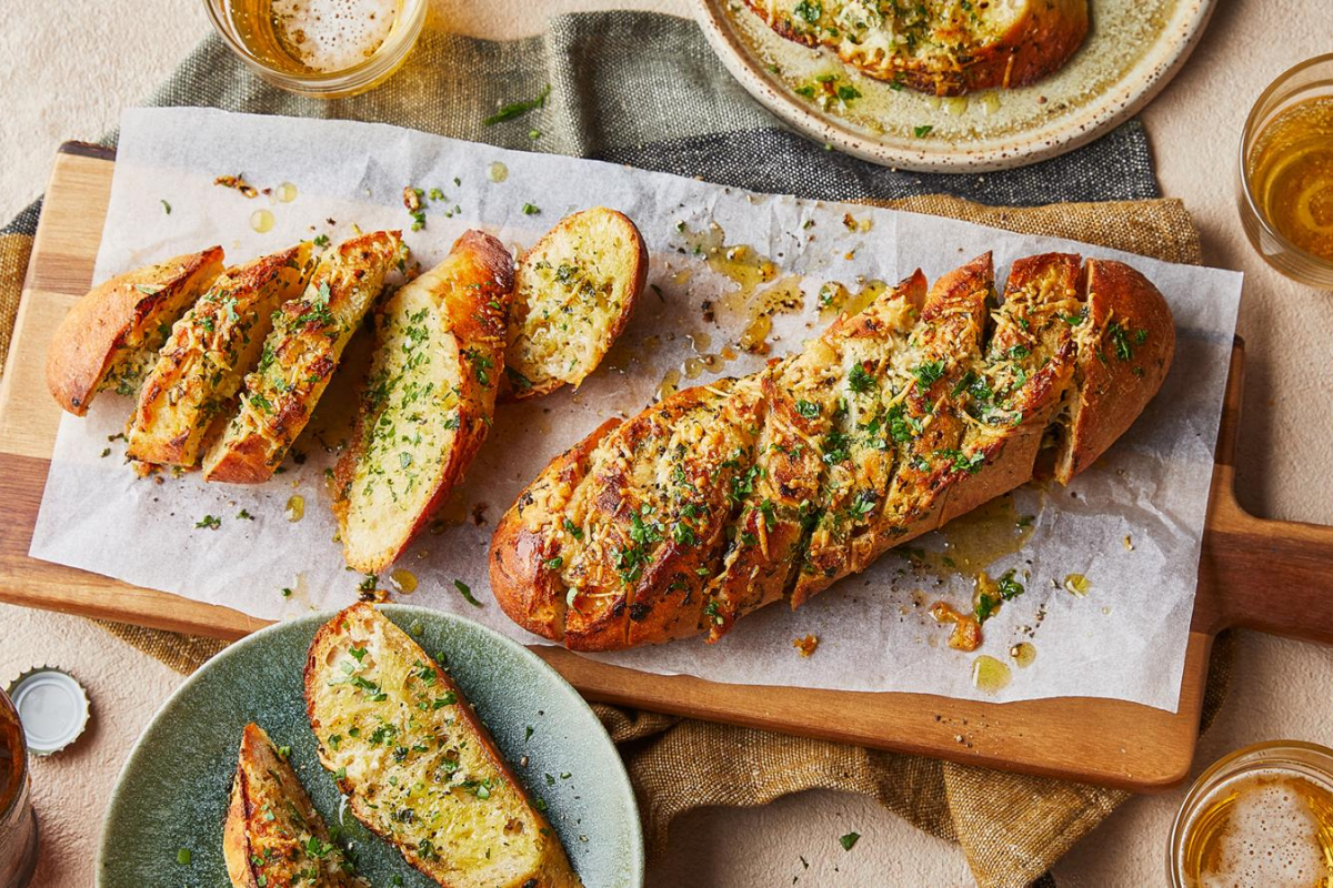 Make crispy, buttery garlic bread at home in 15 minutes. Simple recipe with garlic butter, herbs, and optional cheese. Perfect with pasta or soup.