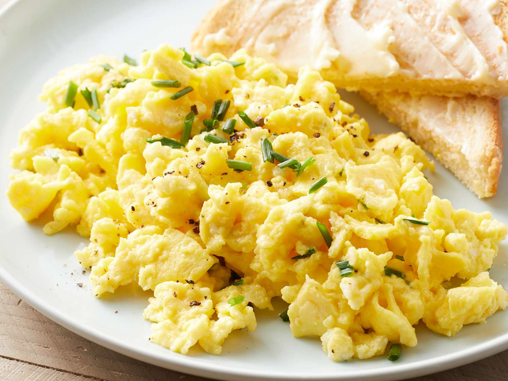 Master two methods for perfect scrambled eggs — American fluffy style and French creamy style. Easy techniques with timing and expert tips.