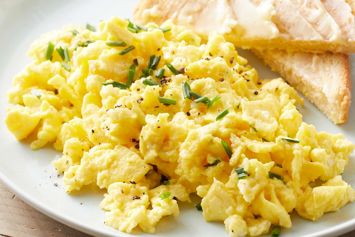 Master two methods for perfect scrambled eggs — American fluffy style and French creamy style. Easy techniques with timing and expert tips.