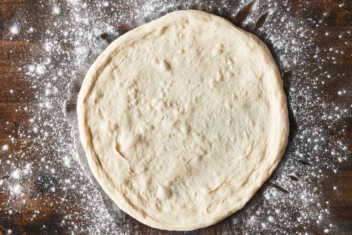 Make restaurant-quality pizza dough at home with 5 simple ingredients. Detailed recipe with kneading, rising, and stretching techniques.