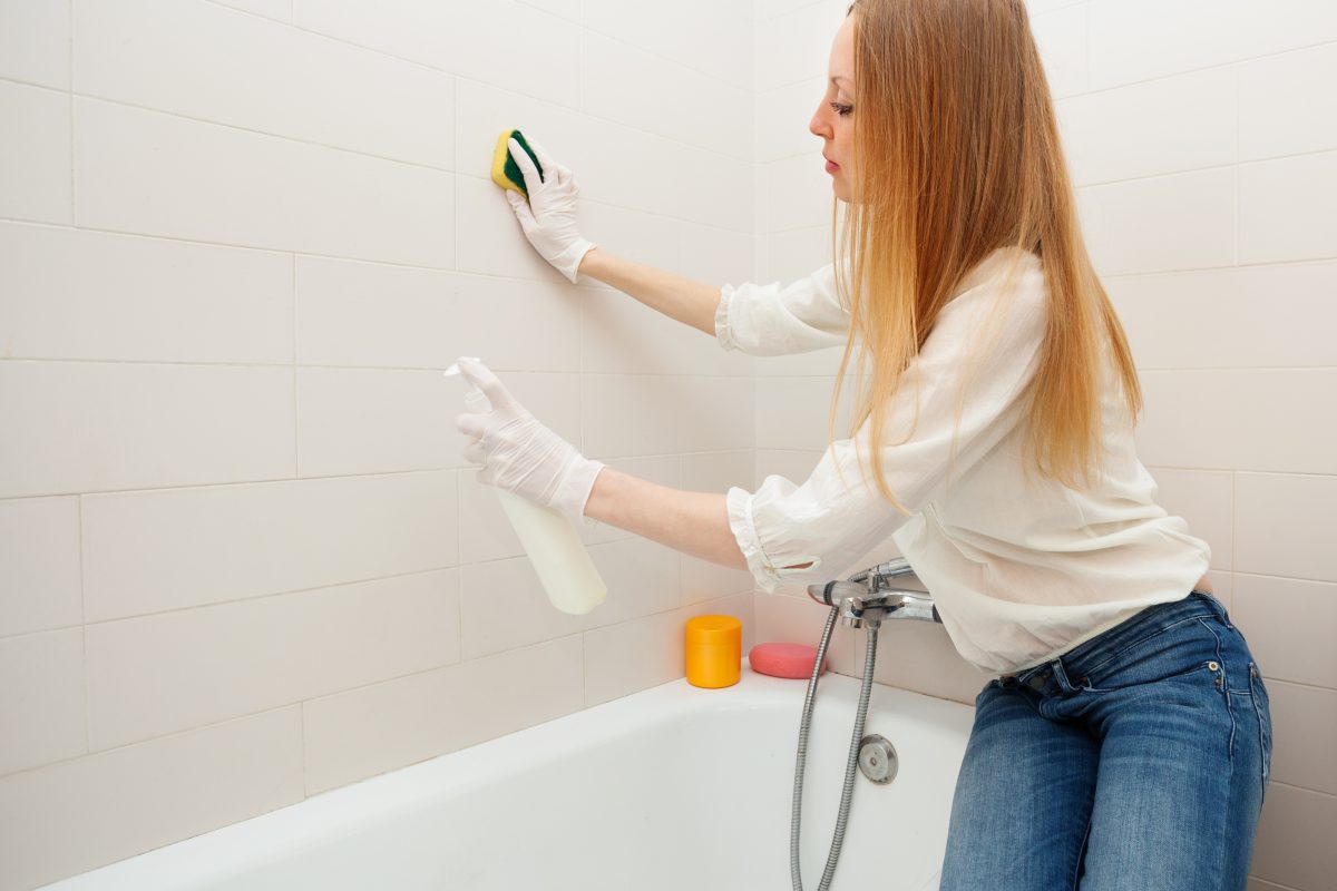 Remove bathroom mold safely with bleach, vinegar, or hydrogen peroxide. Clean tile grout, shower caulk, and ceiling mold with step-by-step instructions.