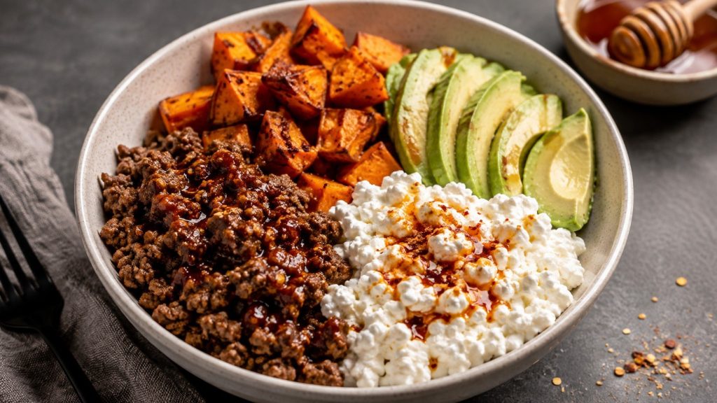 Hot Honey Cottage Cheese Sweet Potato Beef Bowl recipe with ground beef, roasted sweet potato, cottage cheese, avocado and spicy honey, ready in about 35 minutes.