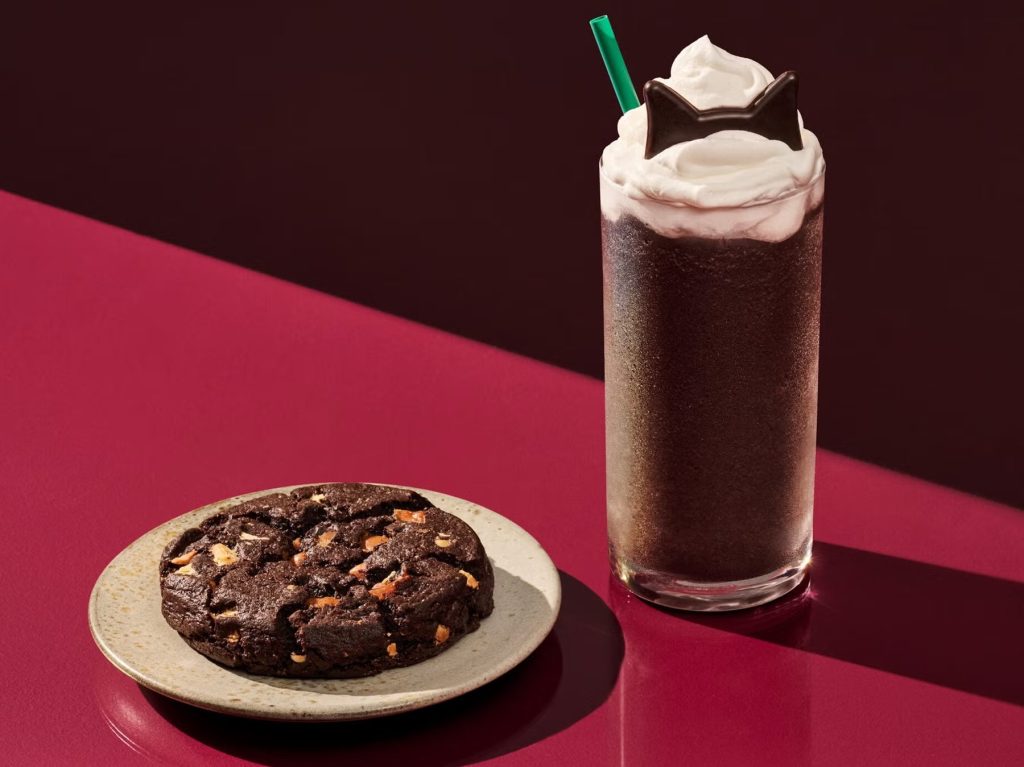 Starbucks Black Cat Frappuccino launches October 22 with chocolate cake flavor, cat-ear toppings, a Black Night Cookie and new Halloween merch.