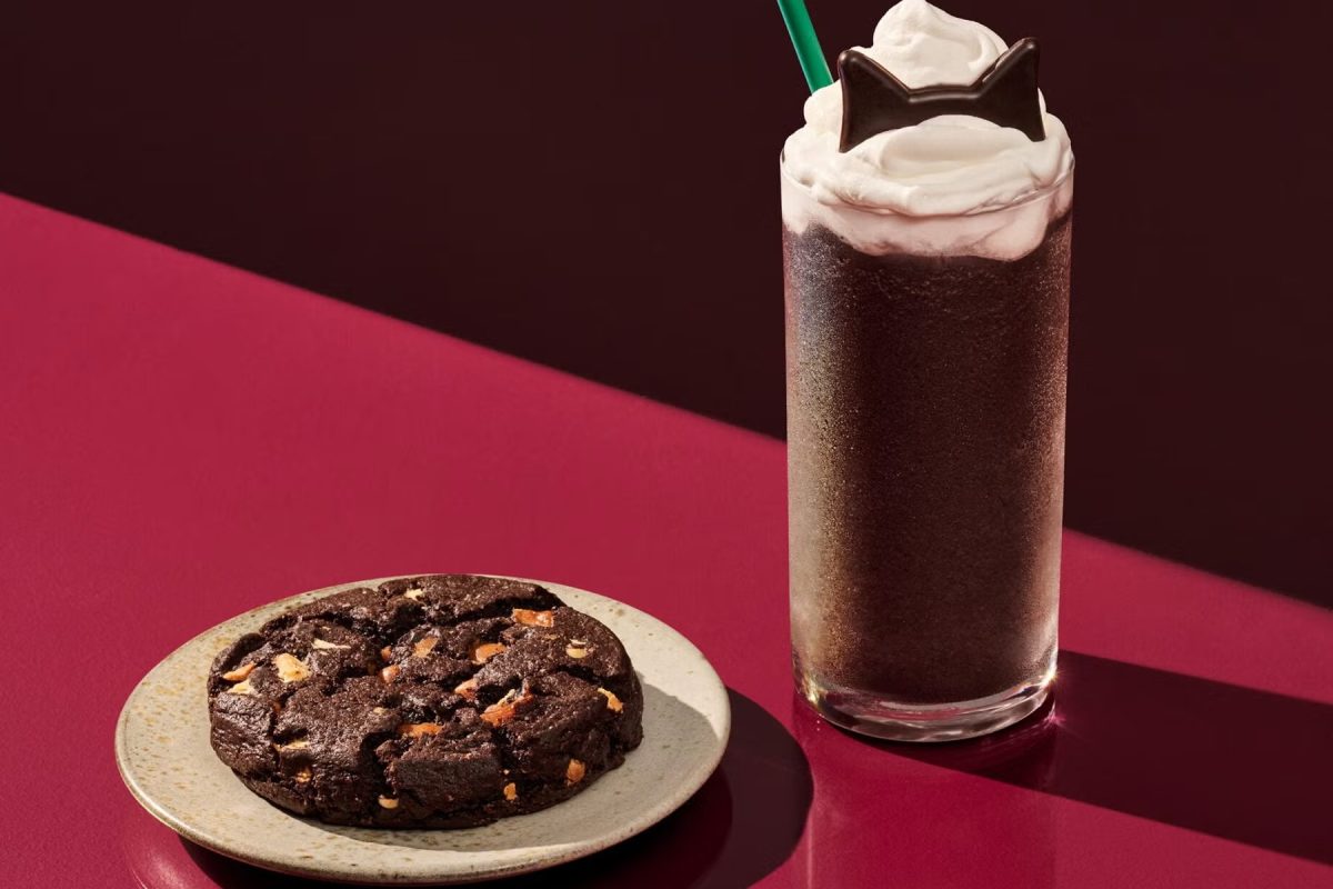Starbucks Black Cat Frappuccino launches October 22 with chocolate cake flavor, cat-ear toppings, a Black Night Cookie and new Halloween merch.